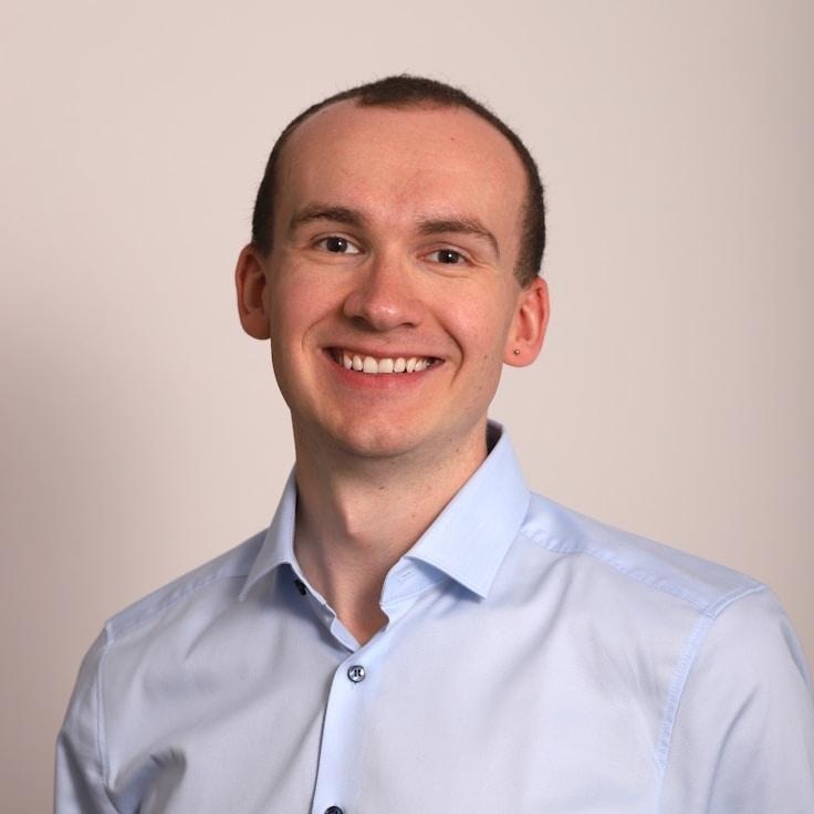 Kaveri Mehta, Lead Design Curator at SummitGrovePaper, reviewing corporate floral arrangements